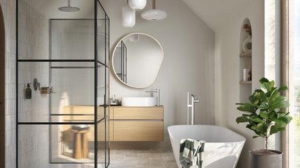 Ein modernes Badezimmer mit einer eleganten Dusche, einem freistehenden Bad und einem großen runden Spiegel an der Wand.